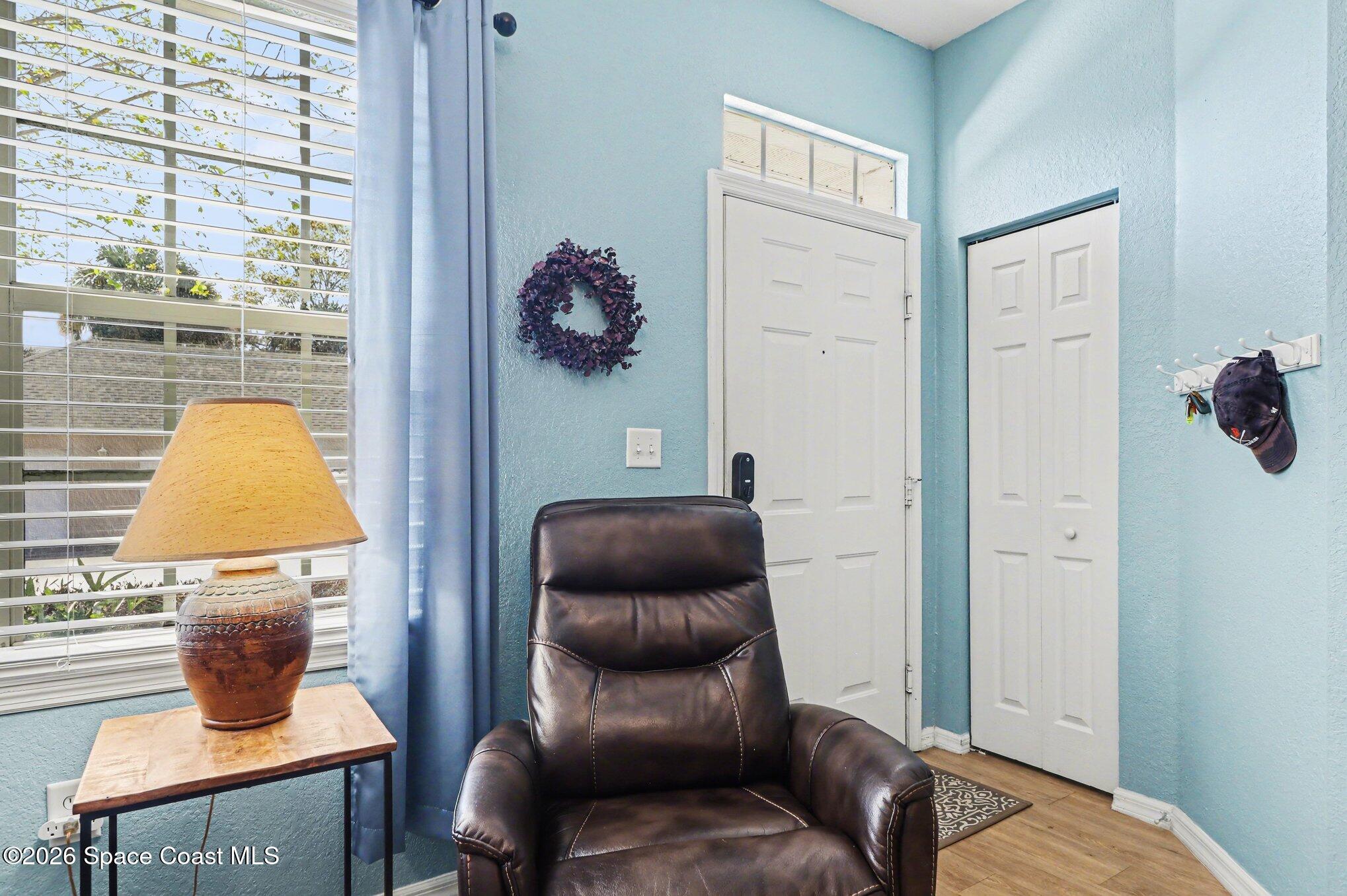 3955 Almeida Court, Unit 103 Melbourne, FL 32901 - Photo 5 of 32 a bedroom with a couch and a lamp next to a window