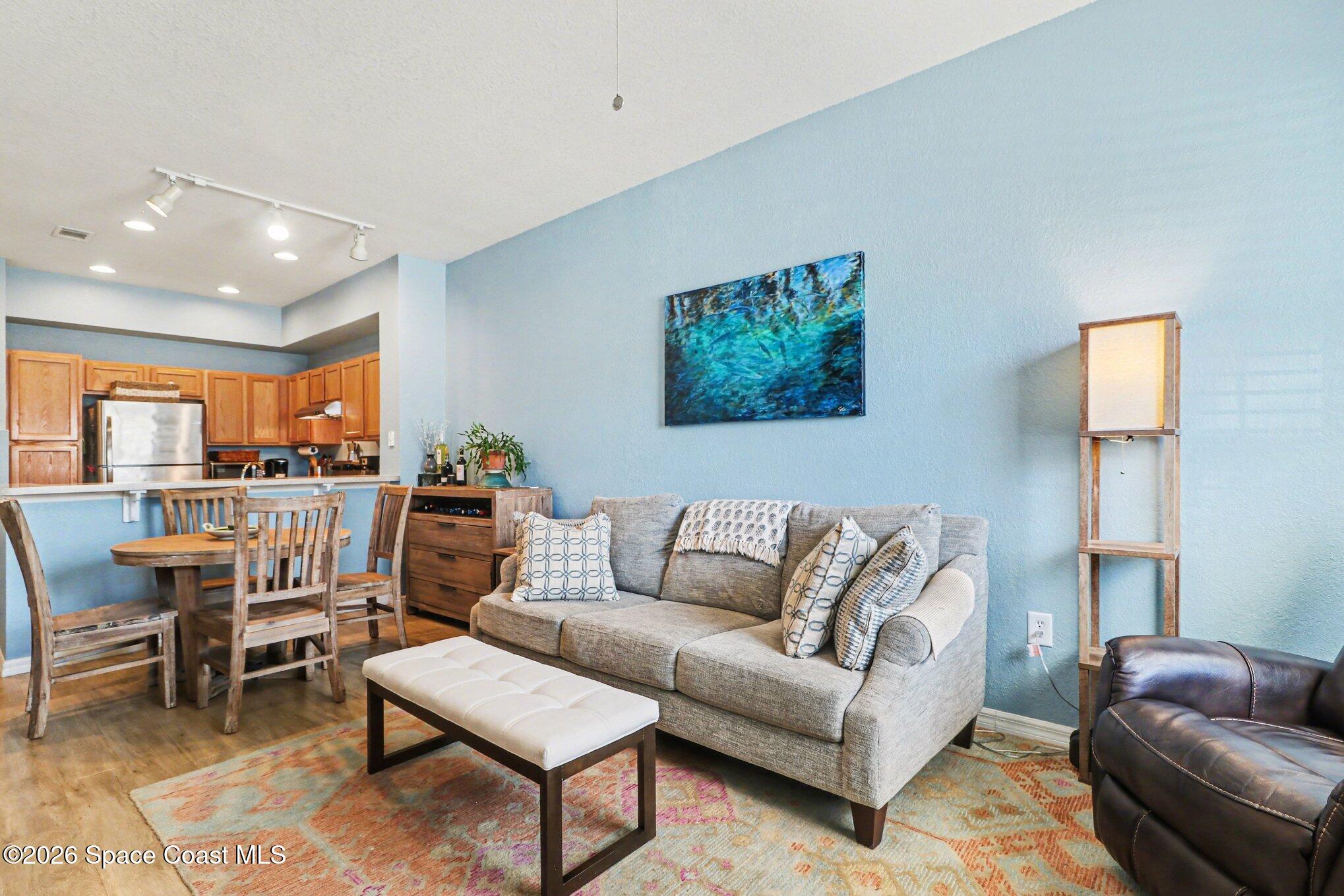 3955 Almeida Court, Unit 103 Melbourne, FL 32901 - Photo 6 of 32 a living room with furniture and a large window