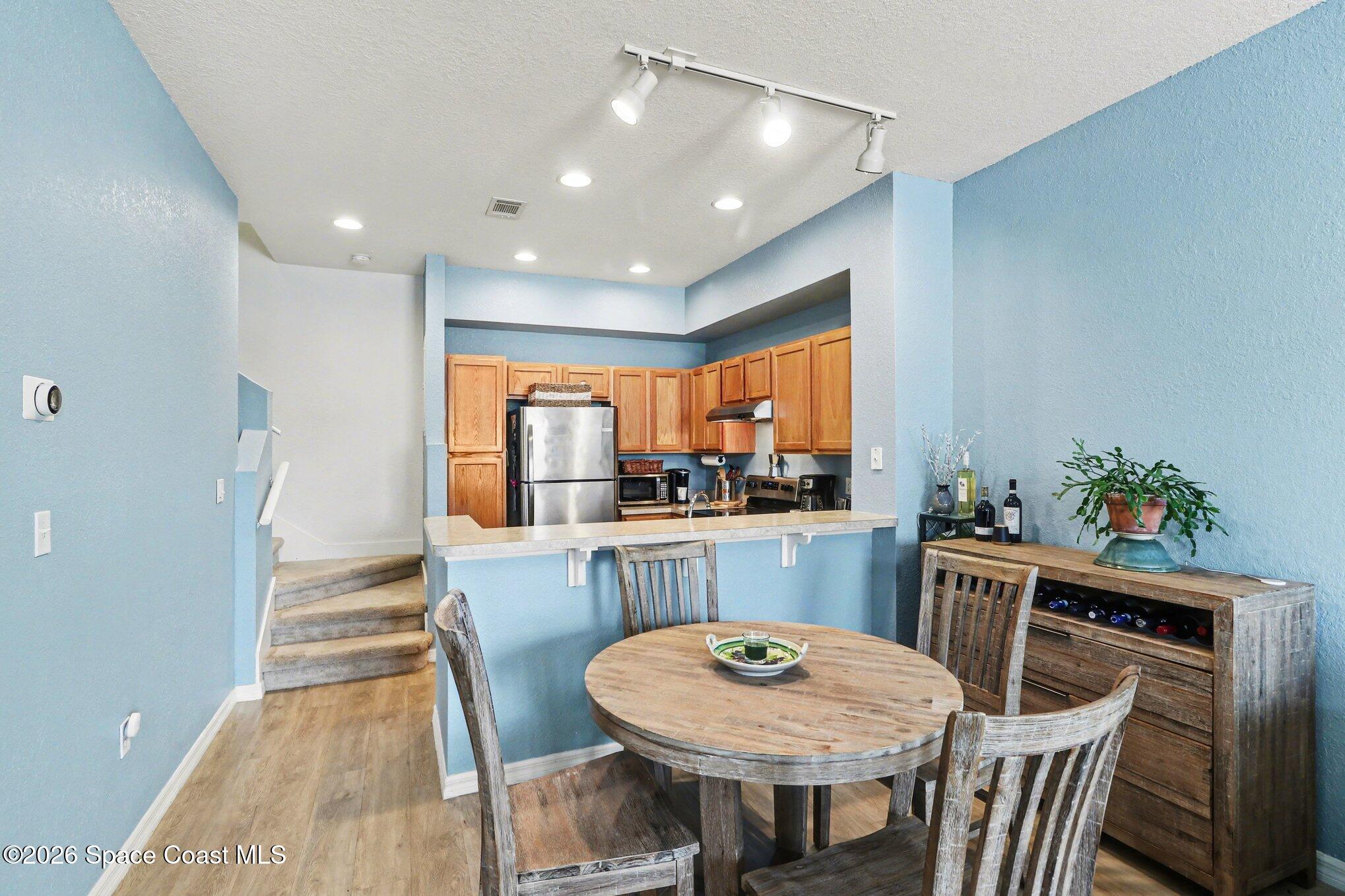 3955 Almeida Court, Unit 103 Melbourne, FL 32901 - Photo 10 of 32 a kitchen with a table and chairs in it