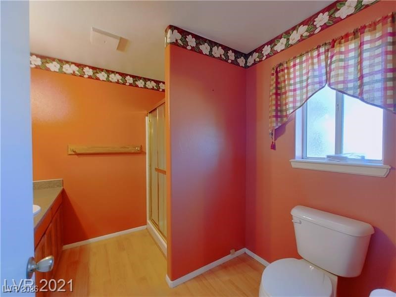 630 East Simkins Road Pahrump, NV 89060 - Photo 11 of 50 Bathroom featuring light wood-style floors, vanity, and a shower stall