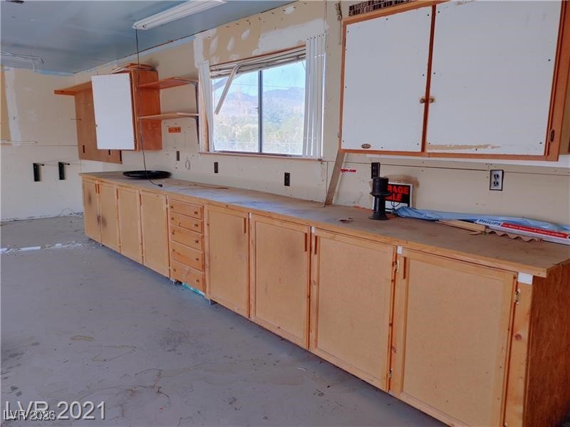 630 East Simkins Road Pahrump, NV 89060 - Photo 29 of 50 garage with concrete floors and open shelves