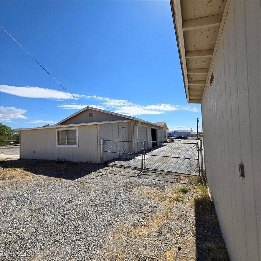 630 East Simkins Road Pahrump, NV 89060 - Photo 34 of 50 View of property exterior featuring a gate
