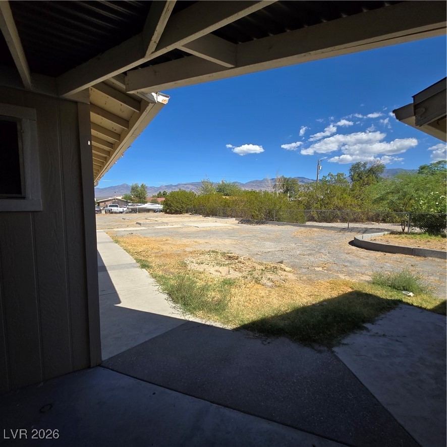 630 East Simkins Road Pahrump, NV 89060 - Photo 35 of 50 View of yard with a mountain view and a patio