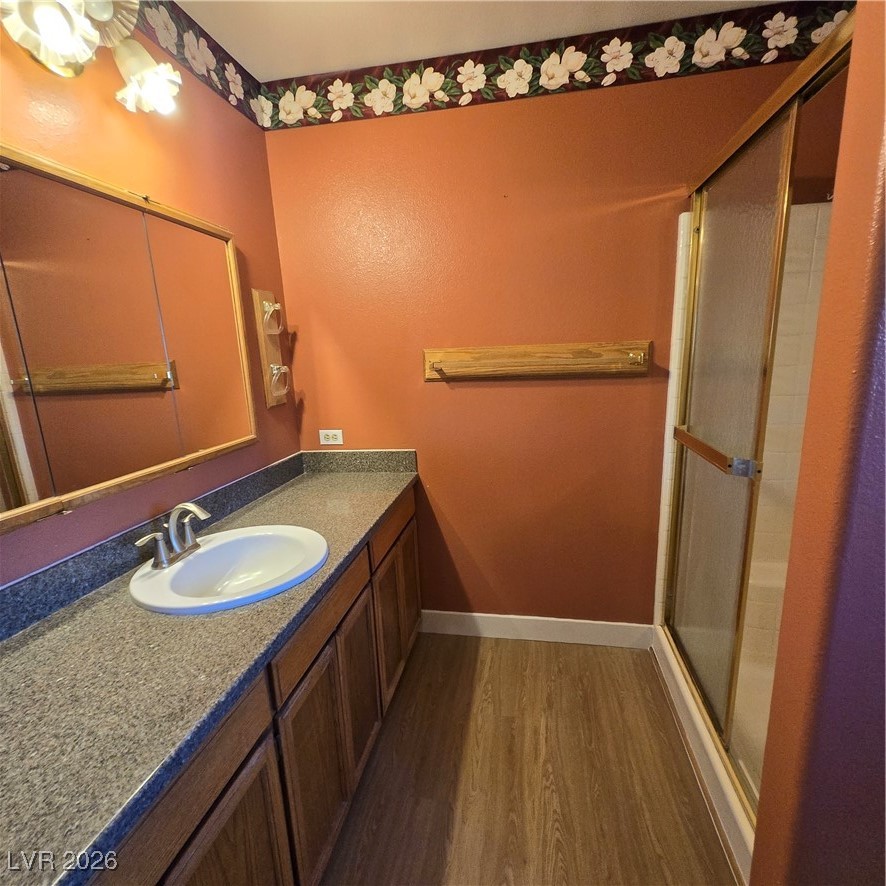 630 East Simkins Road Pahrump, NV 89060 - Photo 44 of 50 Full bathroom featuring vanity, dark wood-type flooring, and a stall shower