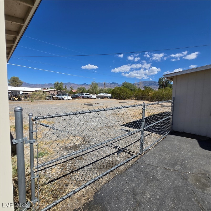 630 East Simkins Road Pahrump, NV 89060 - Photo 46 of 50 View of yard with a mountain view and a gate