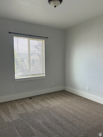 175 North 100th West Centerfield, UT 84622 - Photo 20 of 32 Bright room featuring a window with horizontal blinds, neutral wall paint.