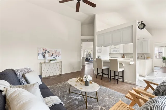 a living room with furniture and kitchen view