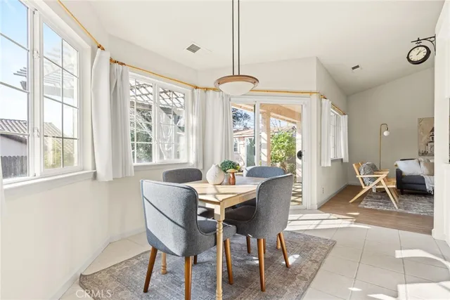 a dining room with furniture water view and a large window