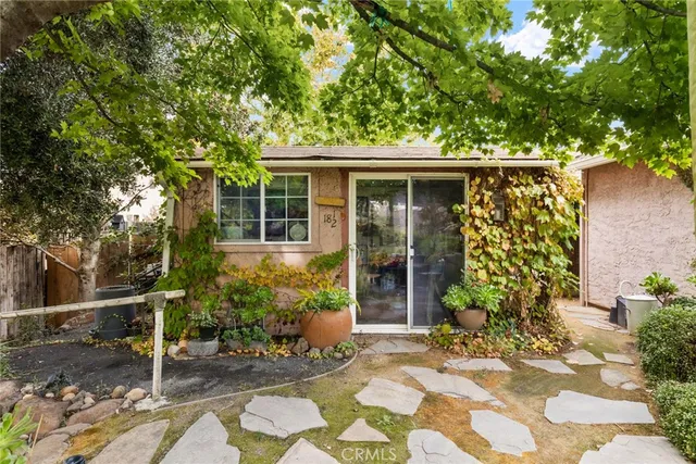 a view of a house with backyard and sitting area