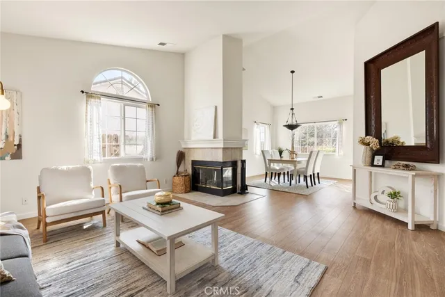 a living room with furniture fireplace and flat screen tv