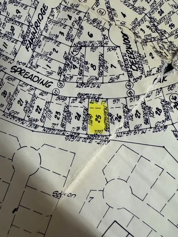 an aerial view of a swimming pool and lounge chairs