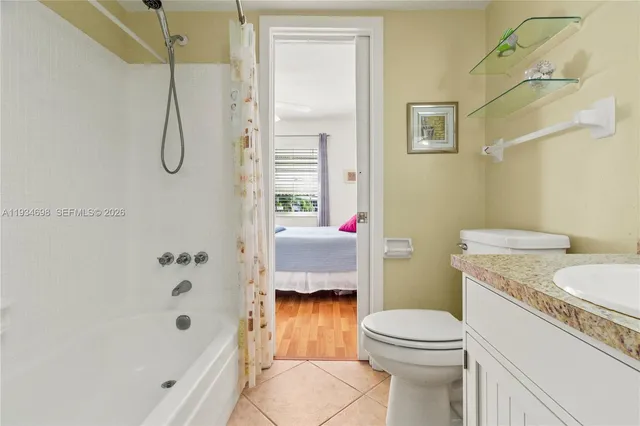 a bathroom with a granite countertop toilet sink and shower