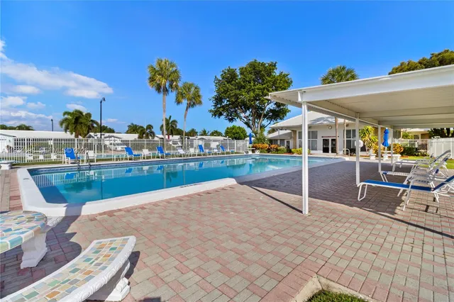 a view of a swimming pool with outdoor seating