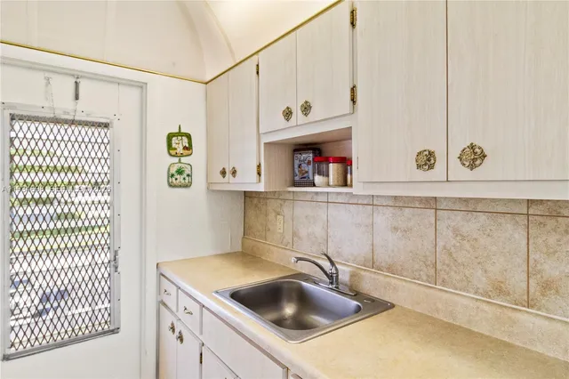 a kitchen with a sink and cabinets