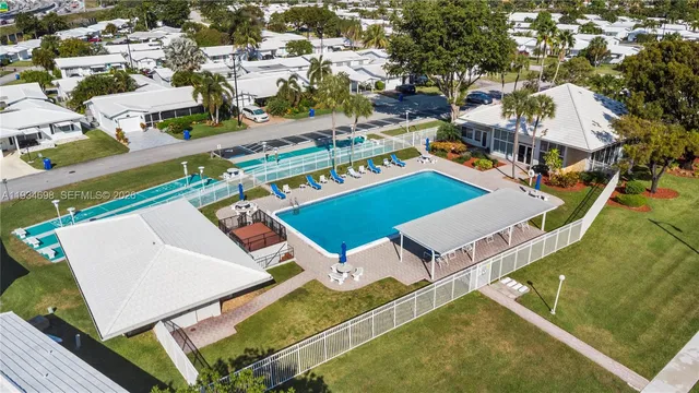 a view of a backyard with swimming pool