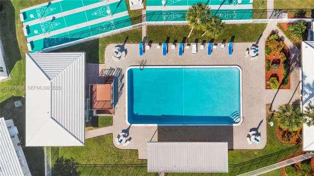 a dining room with stainless steel appliances kitchen island granite top and couches