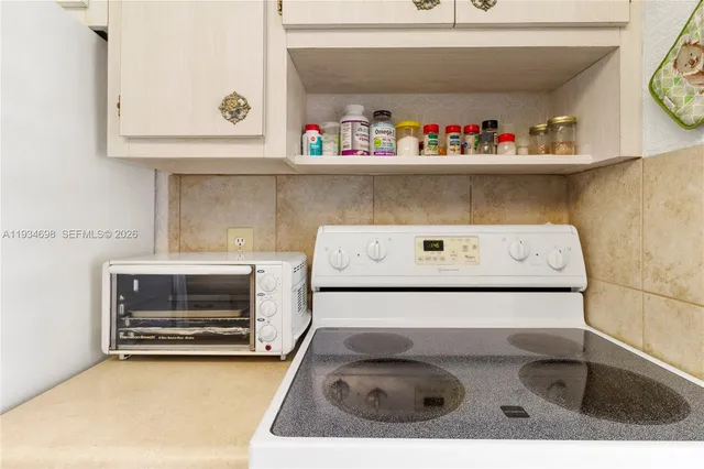 a utility room with a sink and cabinets