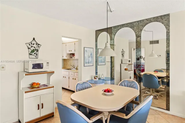 a living room with furniture a table and kitchen chandelier