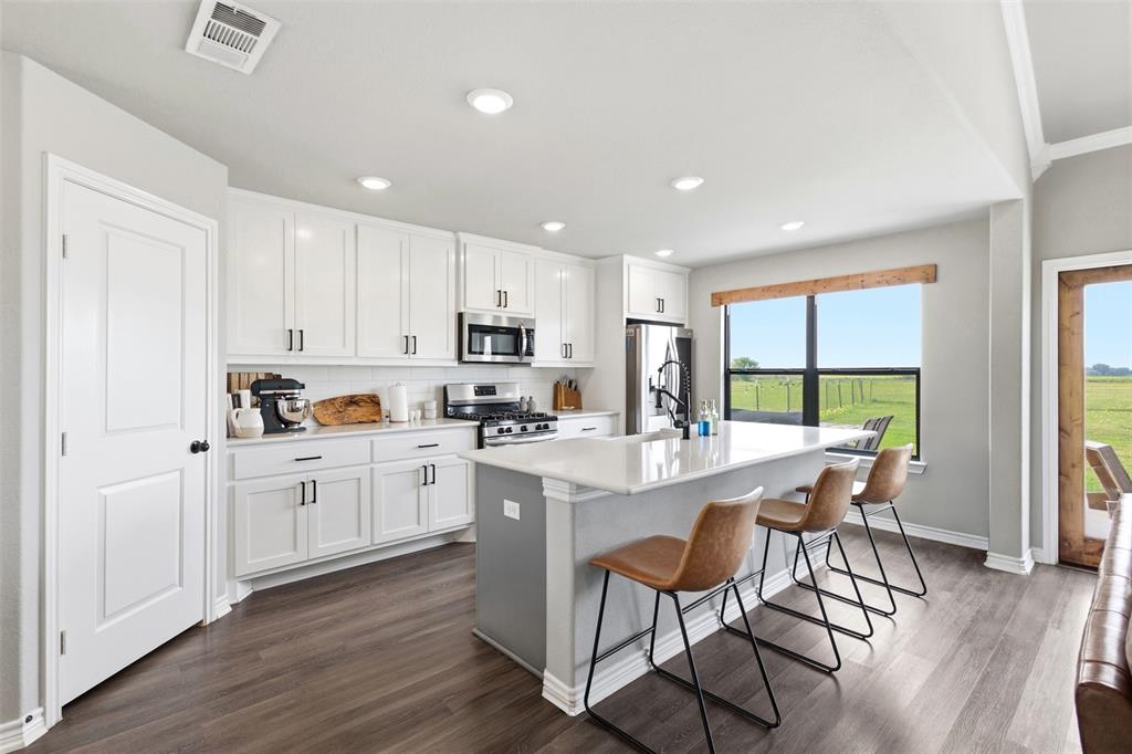 2990 Wilson Road Palmer, TX 75152 - Photo 15 of 40 a kitchen with appliances a table and chairs in it
