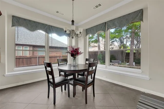 a view of a dining room with furniture and a chandelier