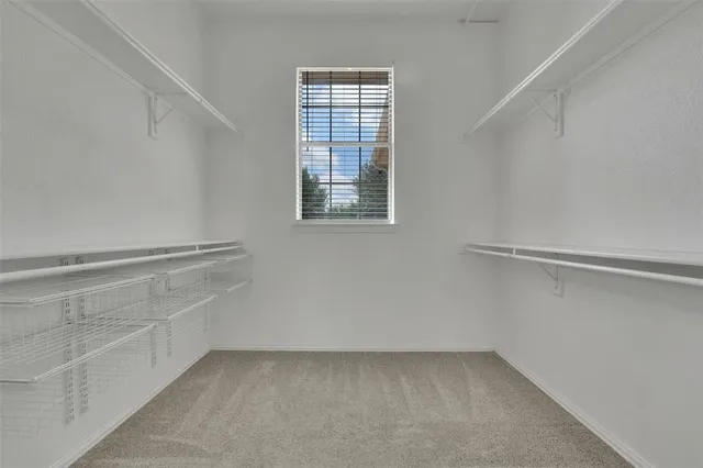 a spacious bathroom with a bathtub a mirror a sinks and a shower
