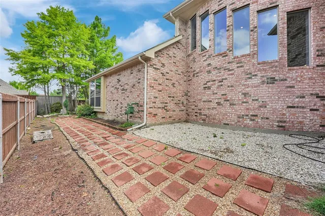 a pathway of a house with a yard