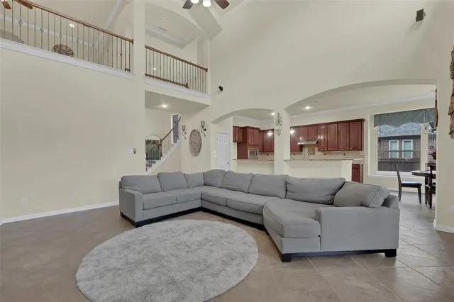 a living room with furniture and stairs