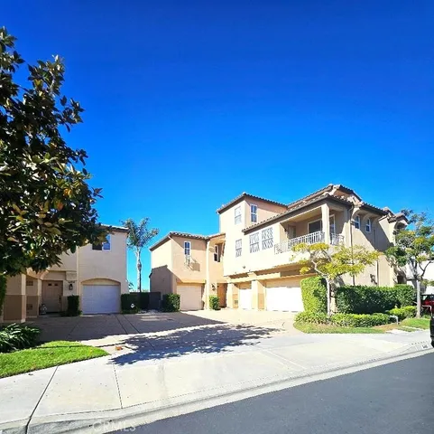 a front view of a house with a garden and yard