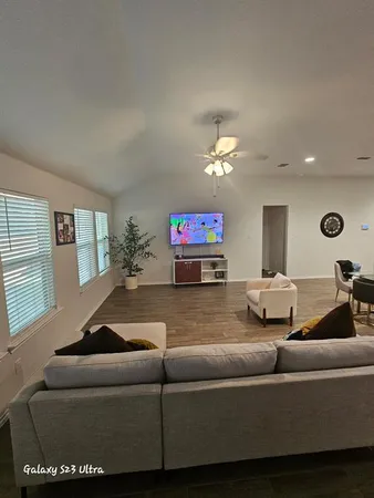 a living room with furniture and a chandelier