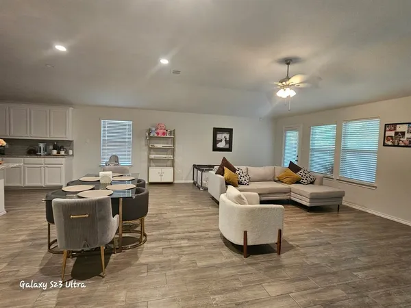 a living room with fireplace furniture and a wooden floor