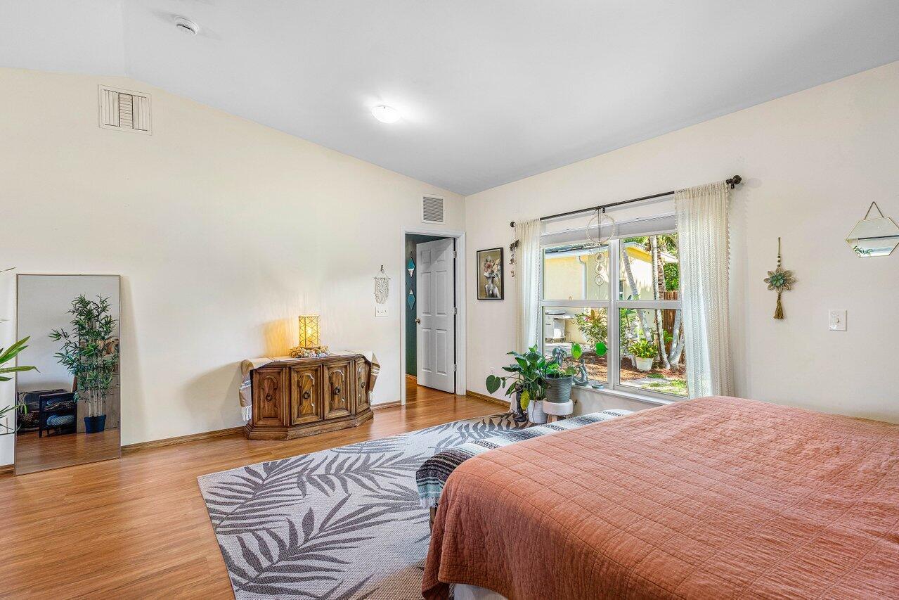 3064 Rostan Lane Palm Springs, FL 33461 - Photo 14 of 49 a bedroom with a large bed and a large window