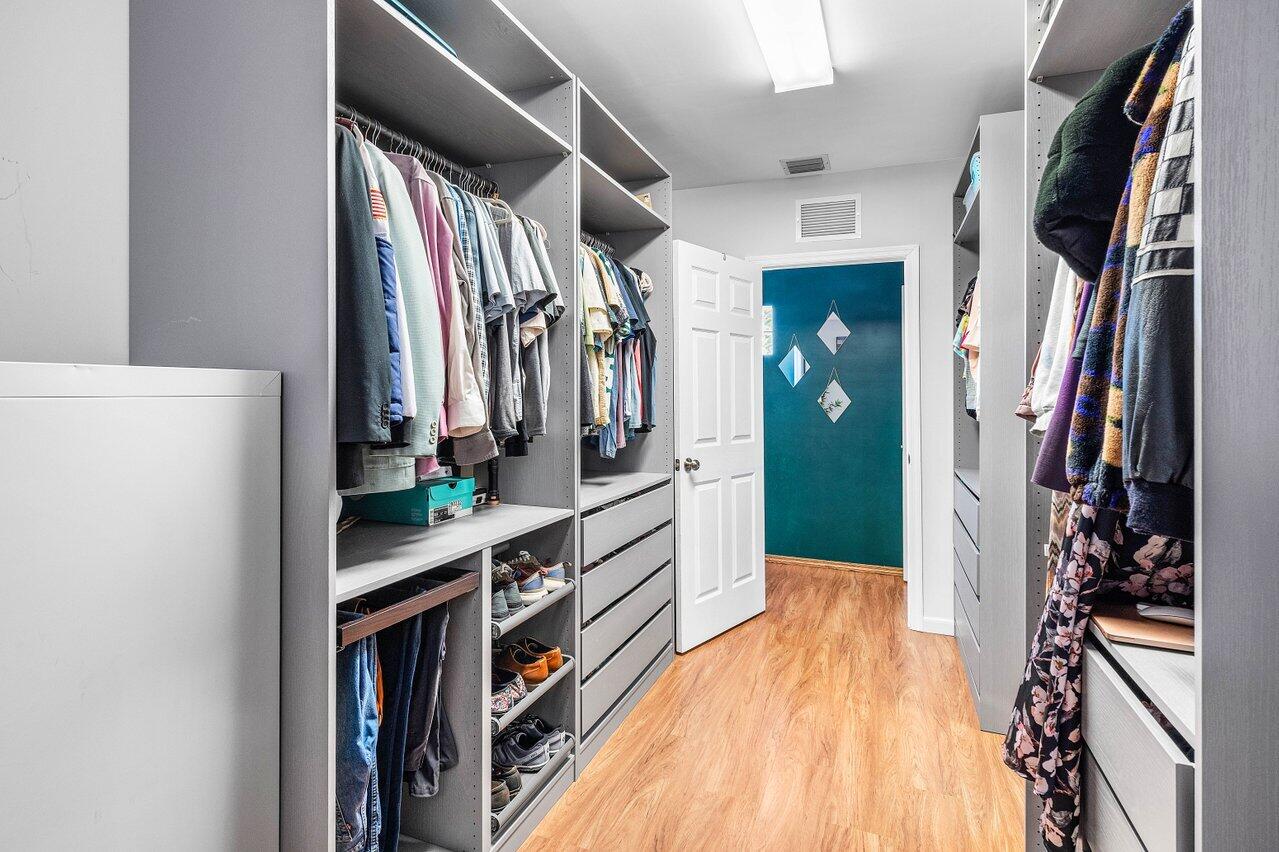 3064 Rostan Lane Palm Springs, FL 33461 - Photo 19 of 49 a view of walk in closet with clothes and shoes