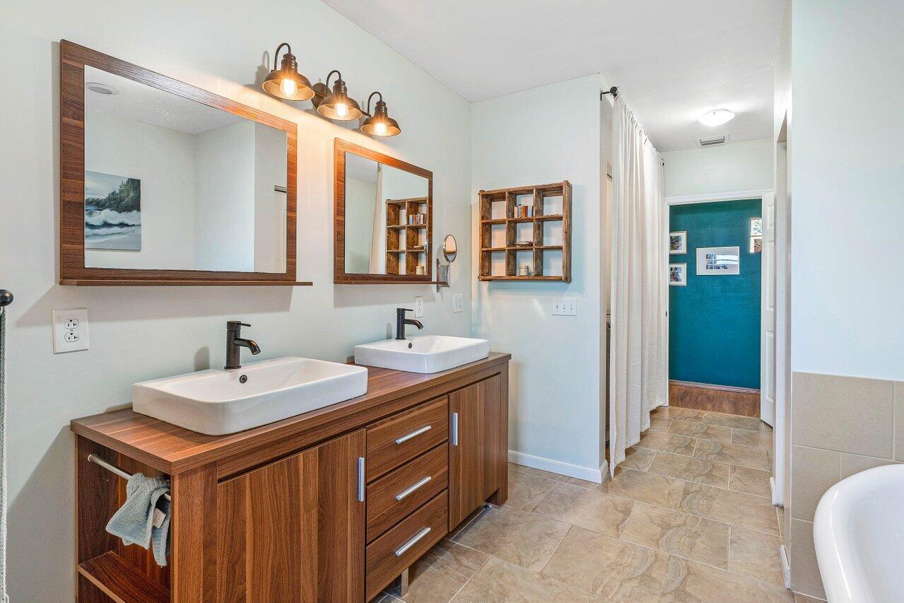 3064 Rostan Lane Palm Springs, FL 33461 - Photo 21 of 49 a bathroom with a sink and a mirror