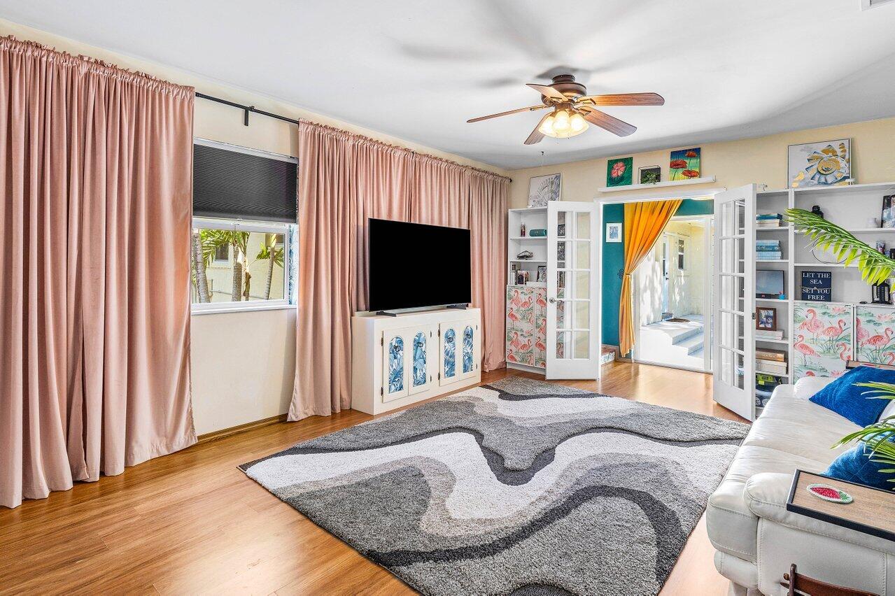 3064 Rostan Lane Palm Springs, FL 33461 - Photo 24 of 49 a living room with furniture and a flat screen tv