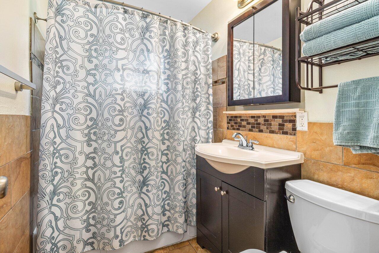 3064 Rostan Lane Palm Springs, FL 33461 - Photo 28 of 49 a bathroom with a sink toilet and shower