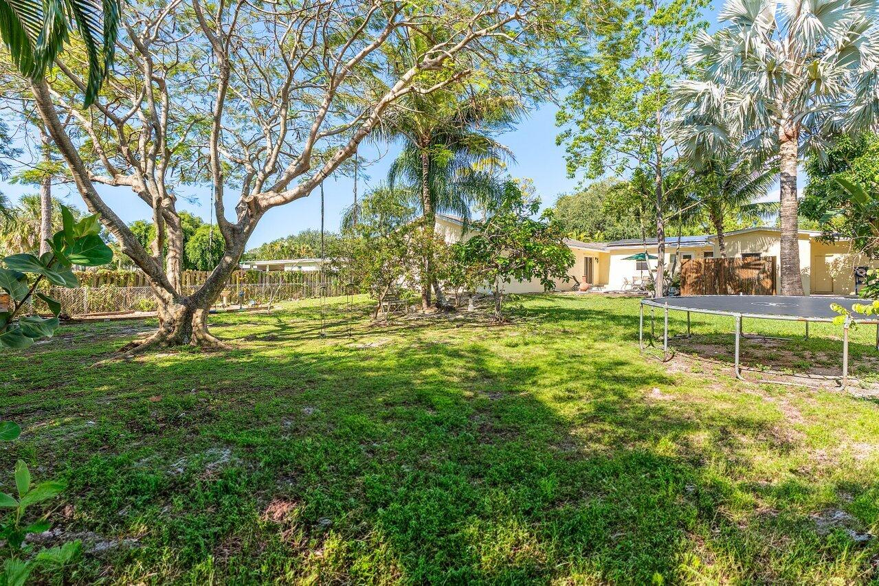 3064 Rostan Lane Palm Springs, FL 33461 - Photo 38 of 49 a view of yard with swimming pool