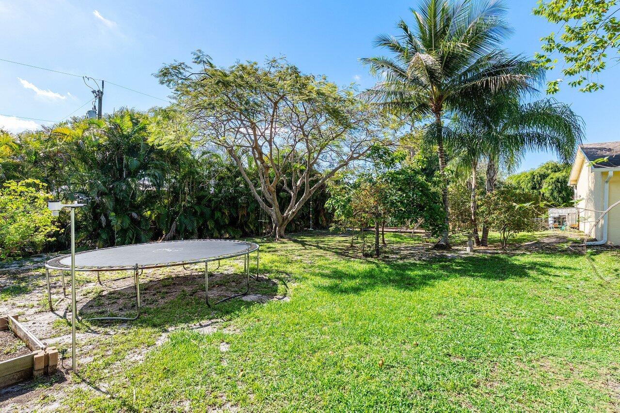 3064 Rostan Lane Palm Springs, FL 33461 - Photo 39 of 49 a view of a backyard with a small pool
