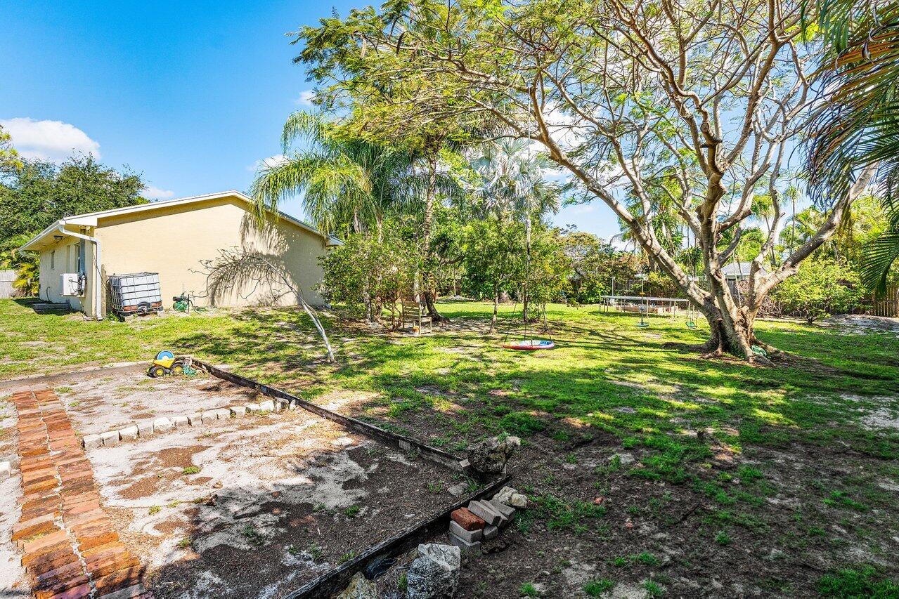 3064 Rostan Lane Palm Springs, FL 33461 - Photo 40 of 49 a view of yard with tree