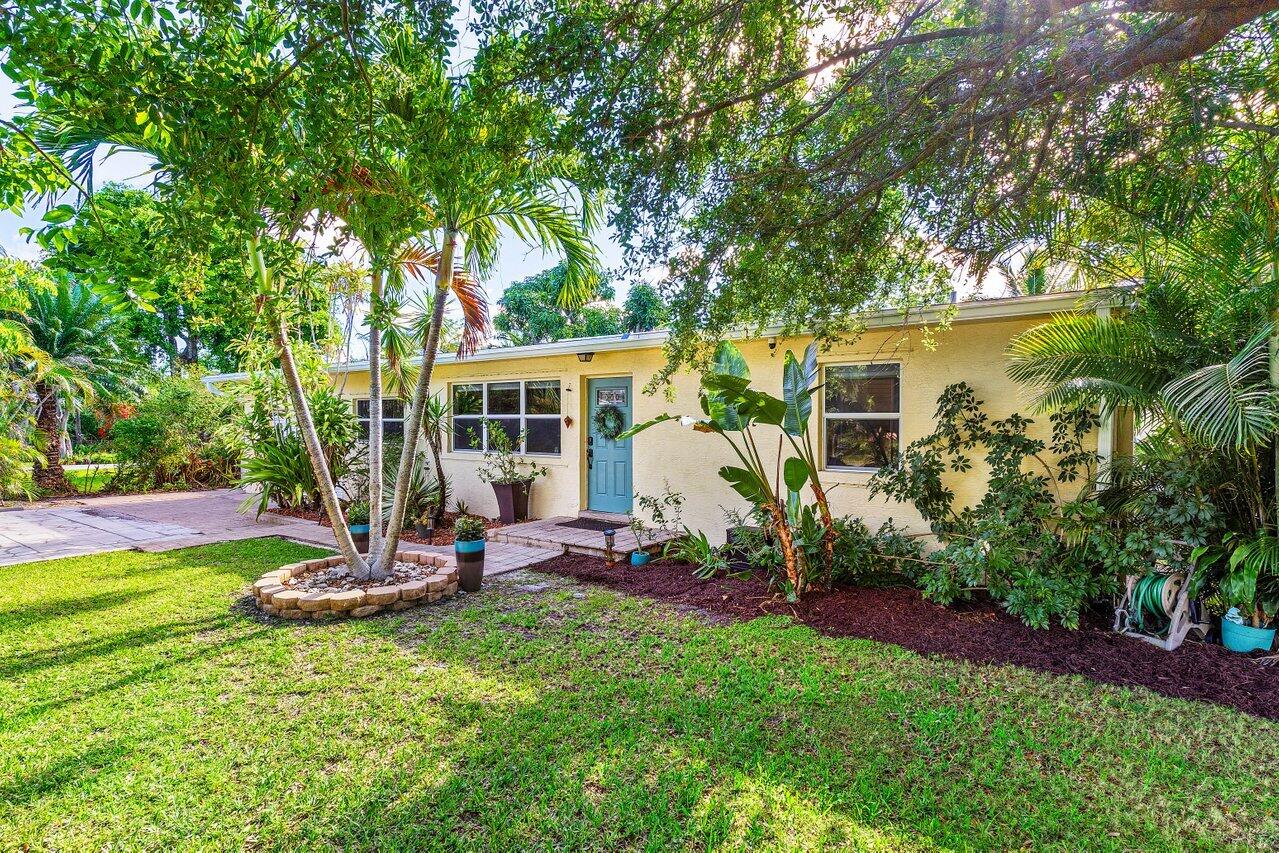 3064 Rostan Lane Palm Springs, FL 33461 - Photo 4 of 49 a view of a house with backyard sitting area and garden