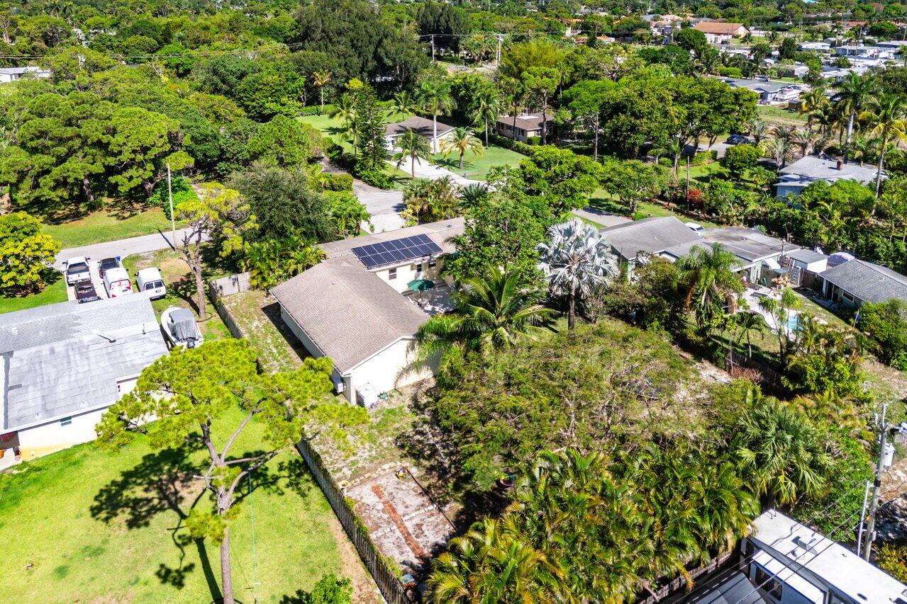 3064 Rostan Lane Palm Springs, FL 33461 - Photo 47 of 49 an aerial view of residential house with outdoor space and trees all around