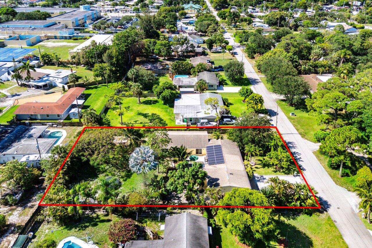 3064 Rostan Lane Palm Springs, FL 33461 - Photo 48 of 49 an aerial view of residential houses with outdoor space and trees all around