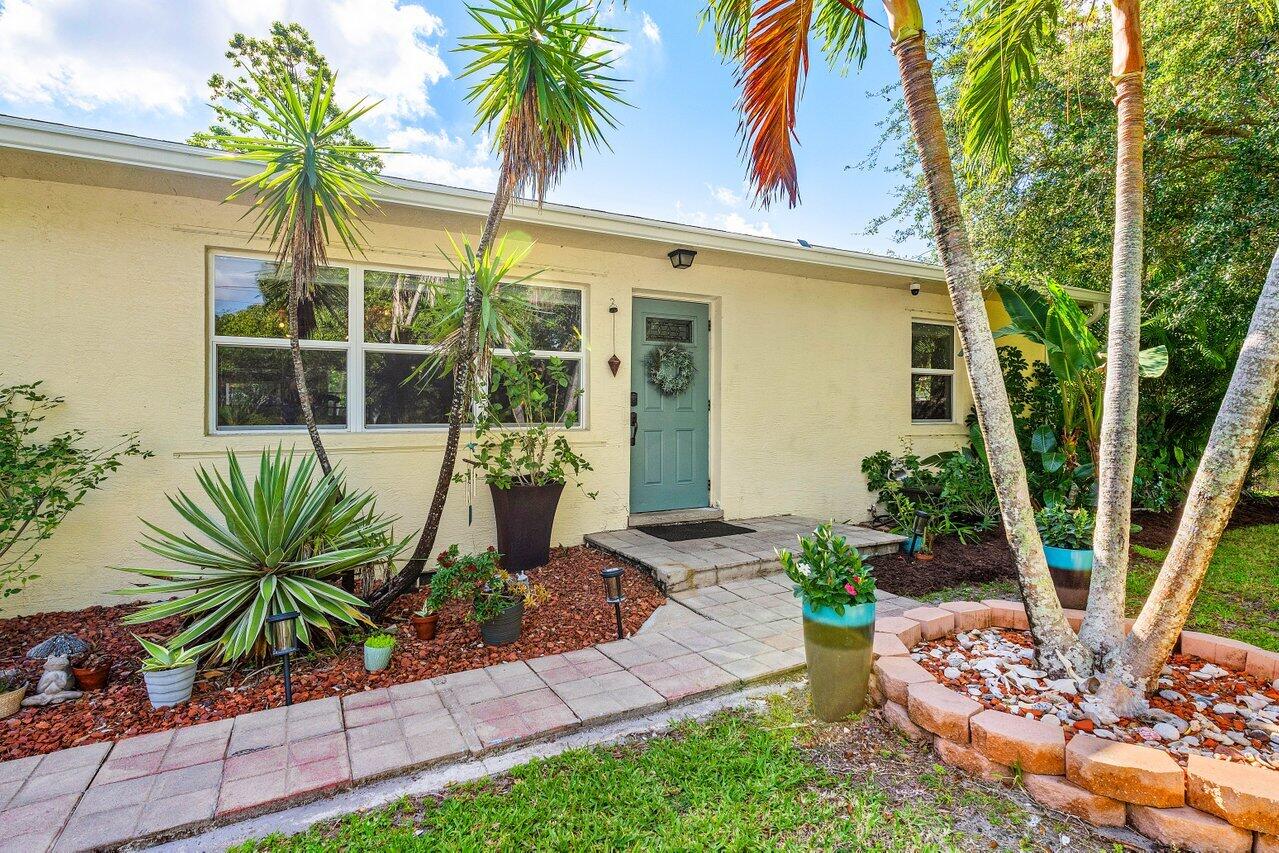3064 Rostan Lane Palm Springs, FL 33461 - Photo 5 of 49 a front view of a house with garden