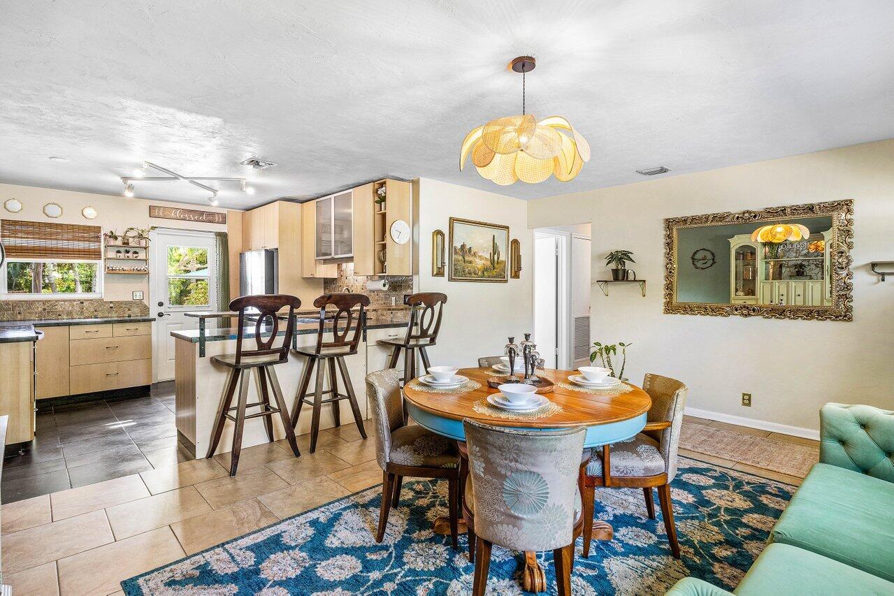 3064 Rostan Lane Palm Springs, FL 33461 - Photo 7 of 49 a view of a dining room with furniture and a large window