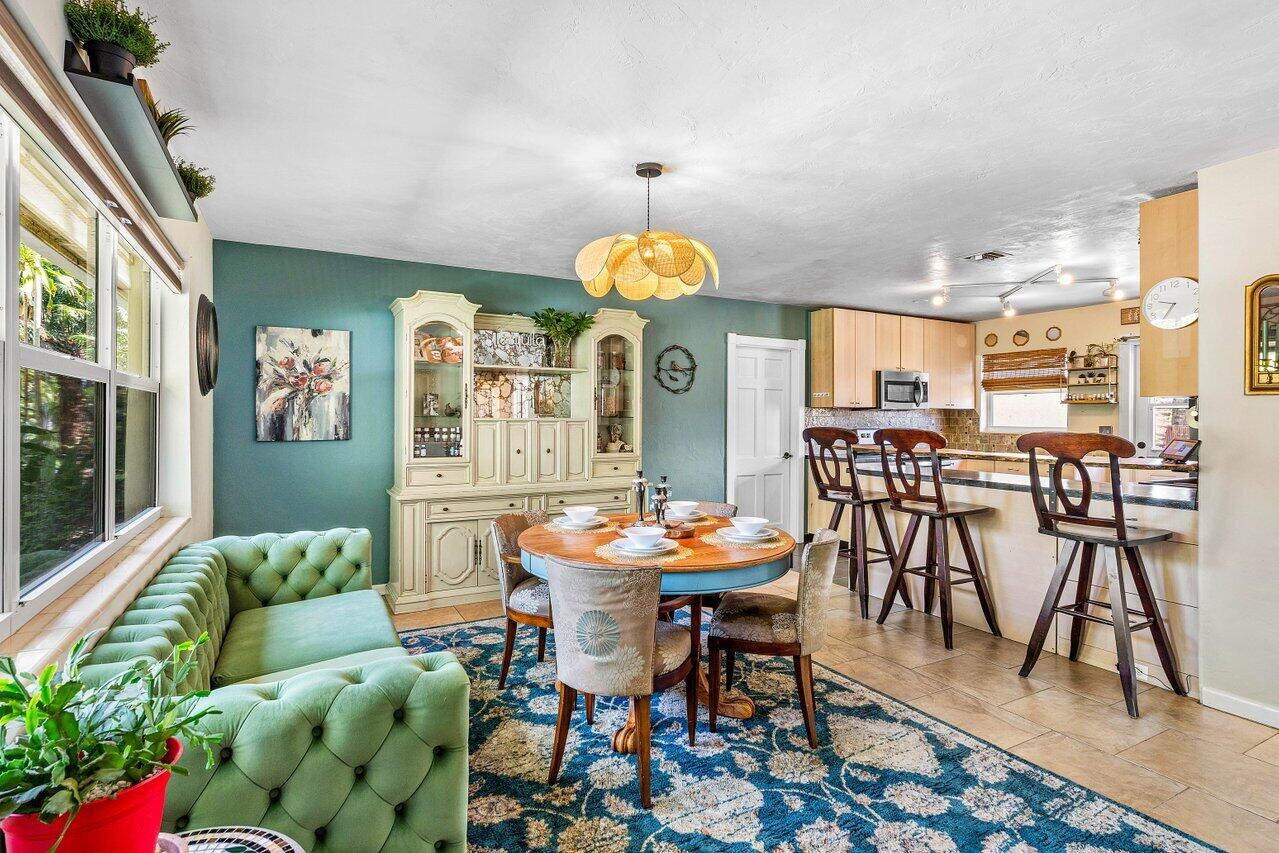 3064 Rostan Lane Palm Springs, FL 33461 - Photo 8 of 49 a view of a dining room with furniture and wooden floor