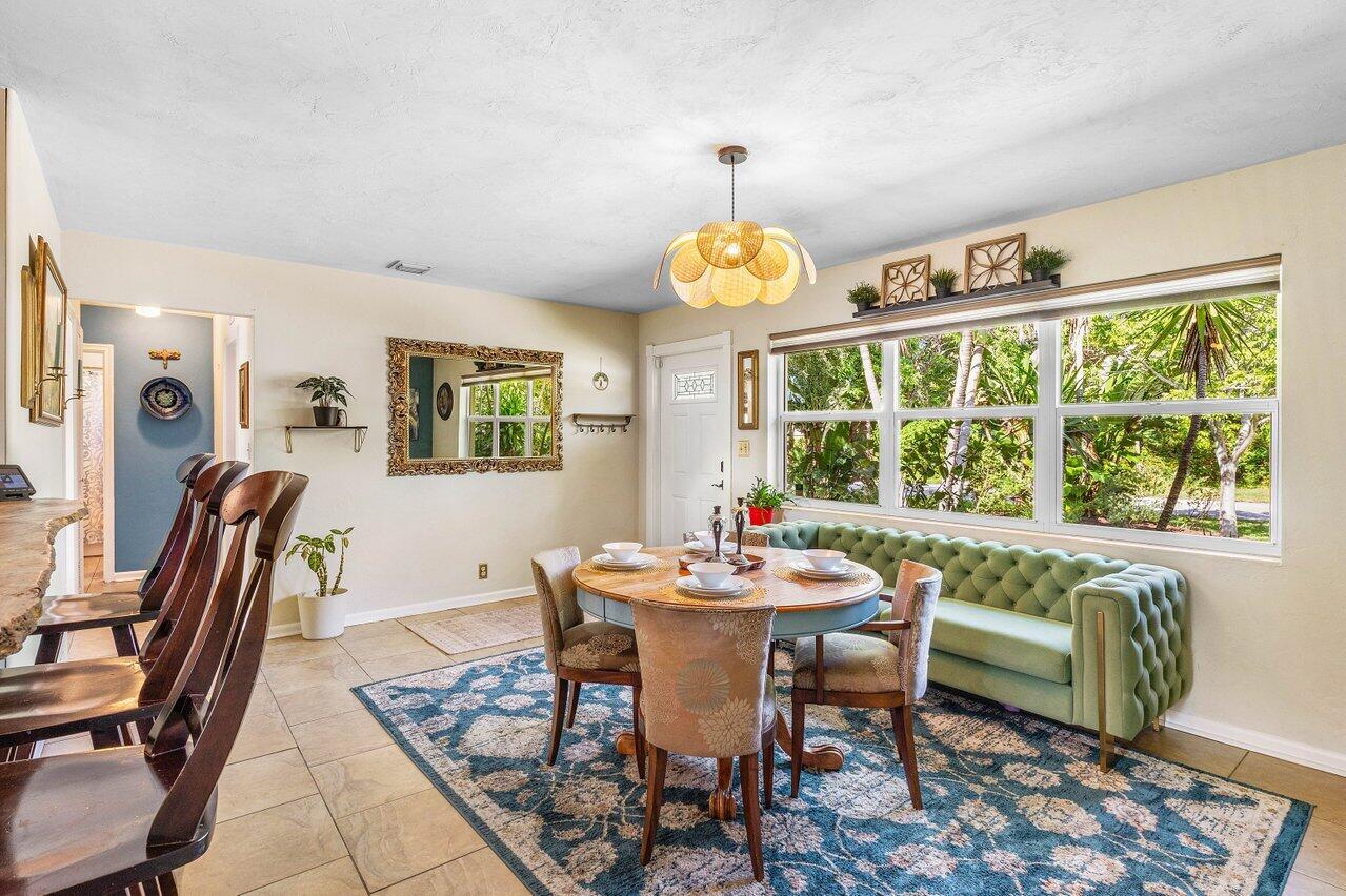 3064 Rostan Lane Palm Springs, FL 33461 - Photo 9 of 49 a view of a dining room with furniture a rug and a large window