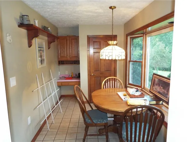 a dining room with furniture a chandelier and window