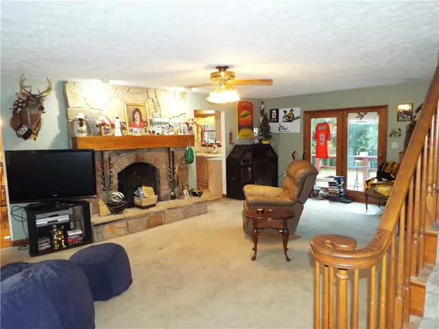 a living room with furniture a fireplace and a flat screen tv