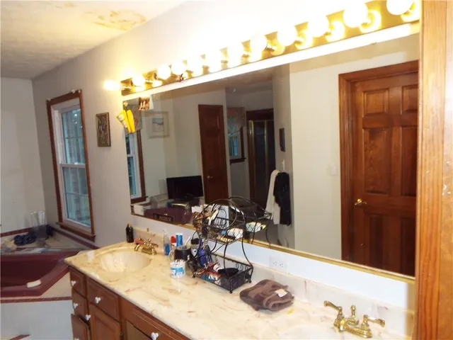 a bathroom with double vanity sinks and a mirror