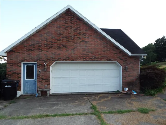 a front view of a house with garage