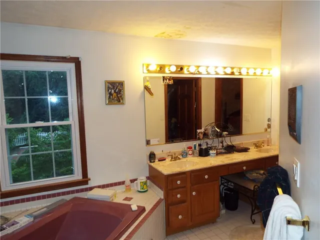 a bathroom with a double vanity sink and mirror